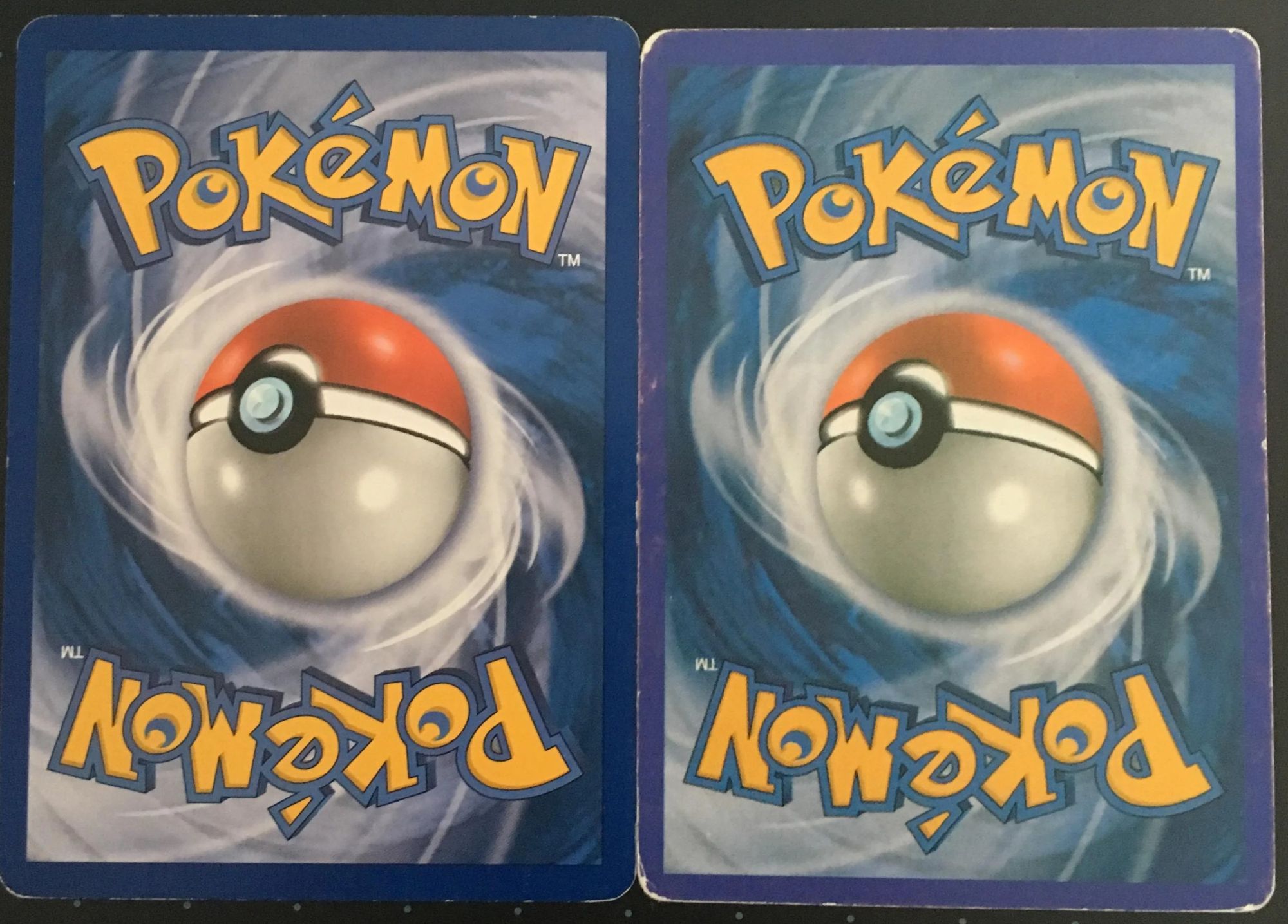 Two card backs side by side: the genuine one on the left with a navy border and a dappled blue swirl, the fake on the right with a pale lilac border and a flat swirl.