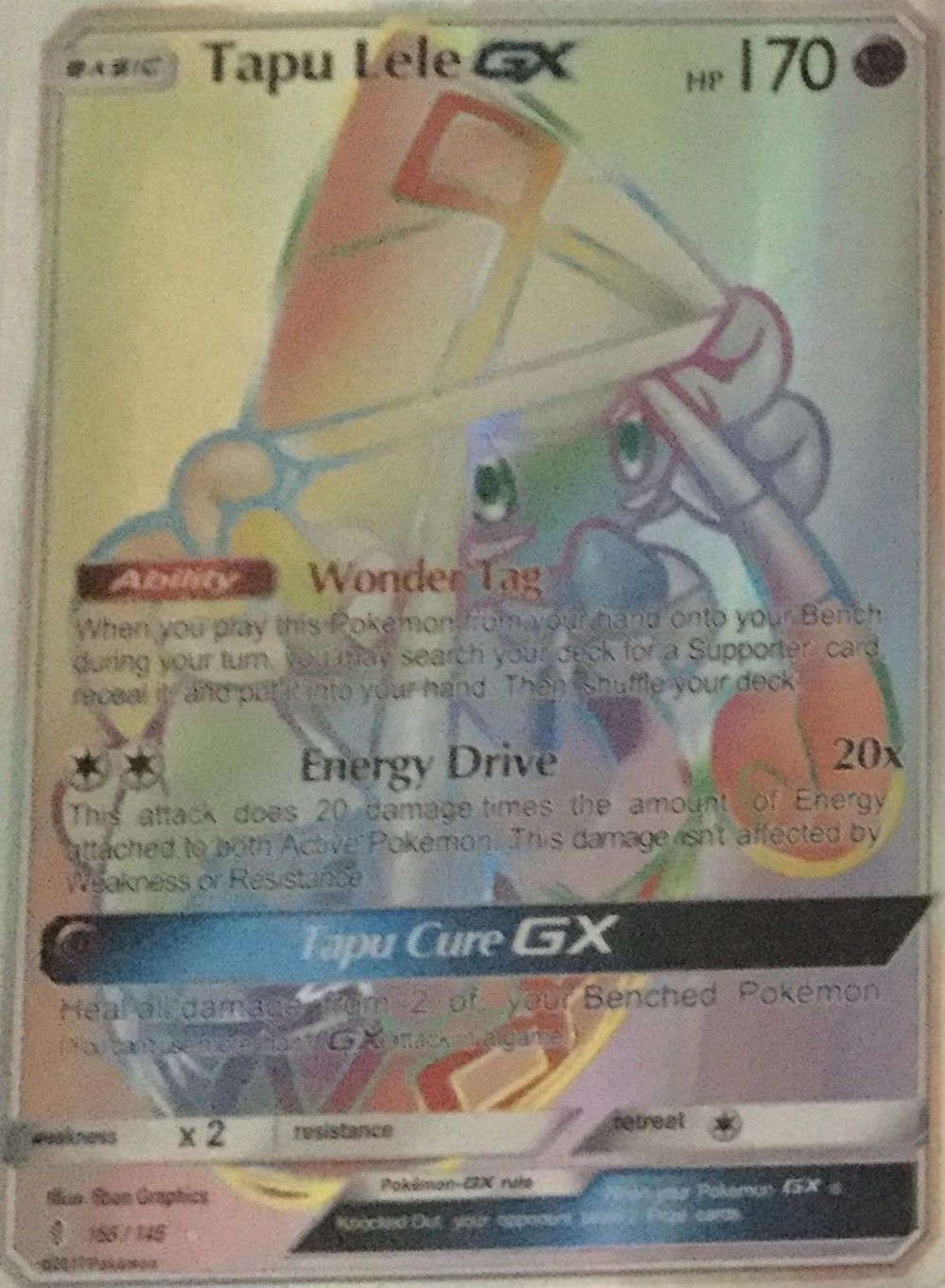 A fake Tapu Lele GX rainbow rare with a uniform pastel sheen over the whole card, no relief and washed-out text.
