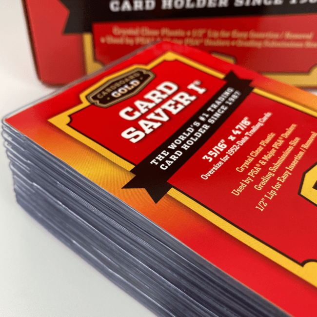 A stack of clear Card Saver I semi-rigid holders in front of their red Cardboard Gold box, the insert card reading 3 5/16 by 4 7/8 inches.