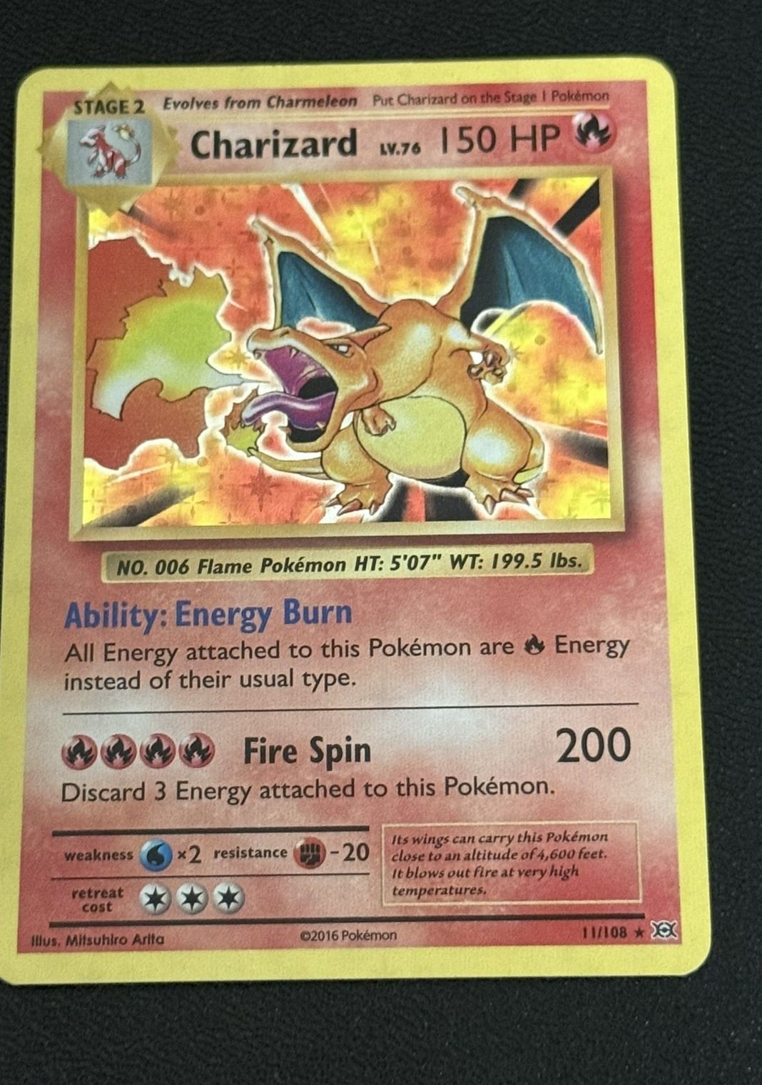 A holo Charizard from XY Evolutions: the foil sits on the artwork window only.