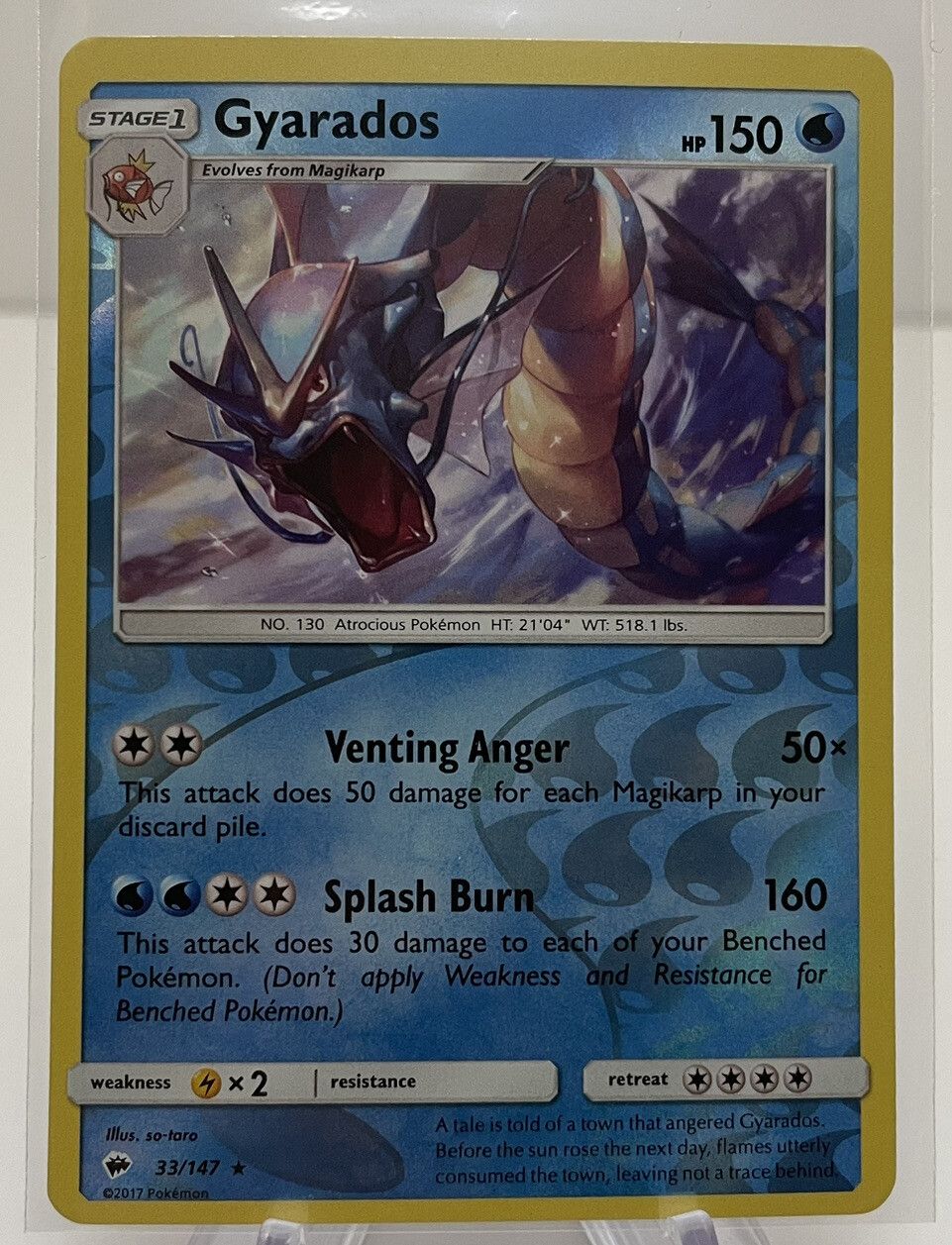A holo Gyarados from Burning Shadows photographed straight on: the water web pattern of droplets over the artwork.