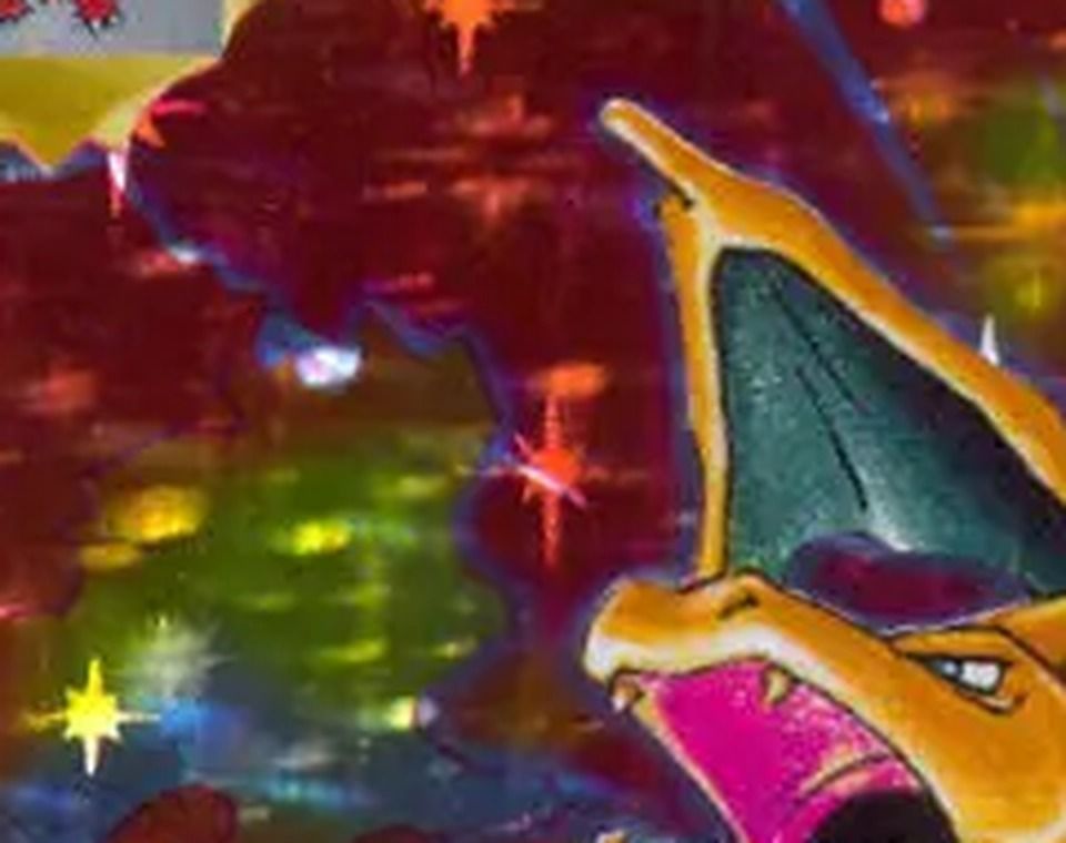 The artwork window of the Base Set Charizard from our scan, zoomed: blurry starbursts of different sizes.