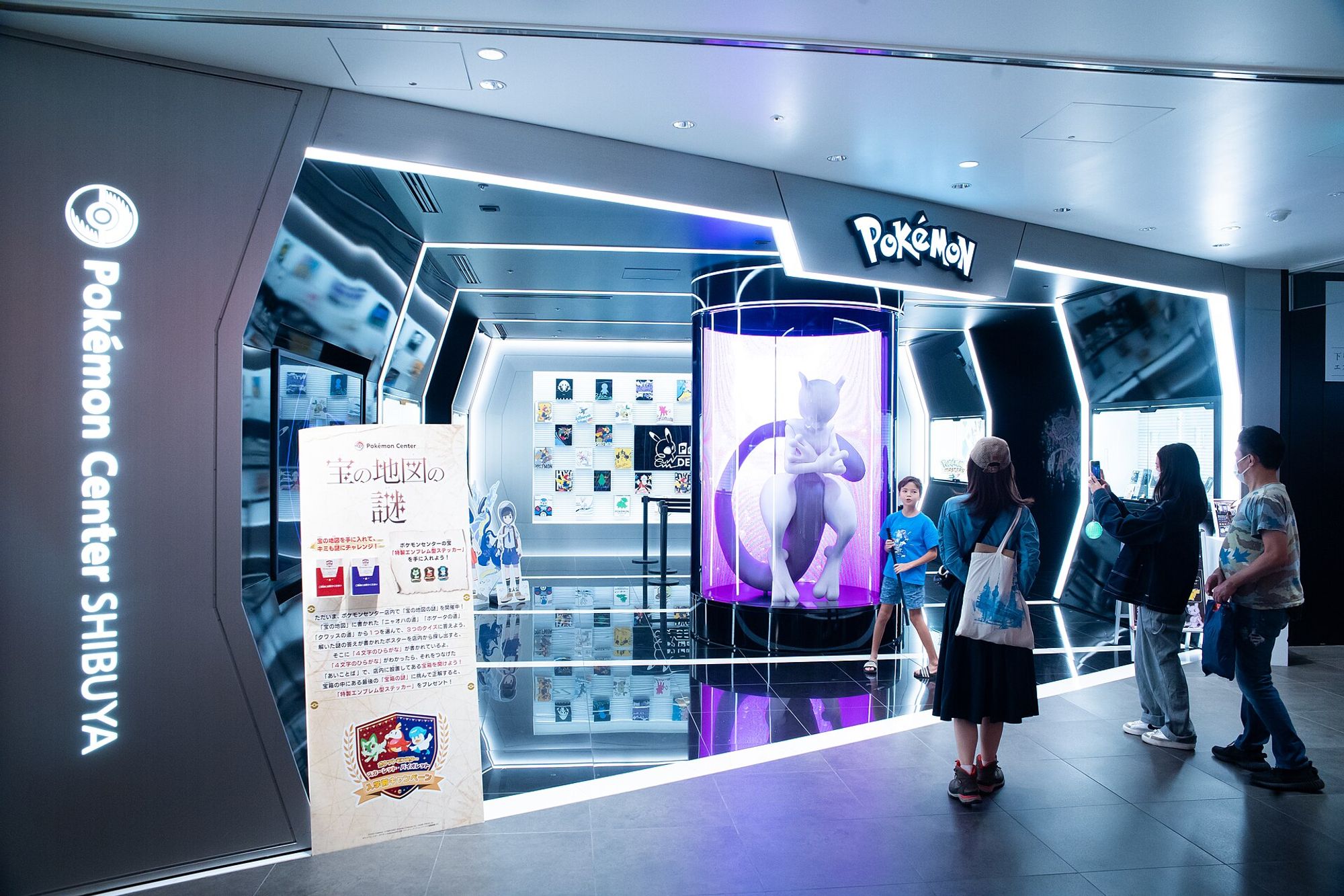 The entrance of Pokémon Center SHIBUYA, with a life-size Mewtwo in a containment tube.
