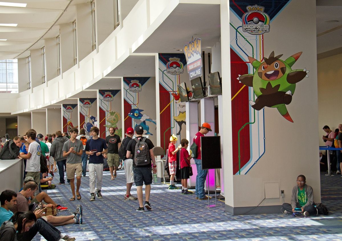Attendees queueing along a hall under Pokémon banners at the 2014 World Championships in Washington.