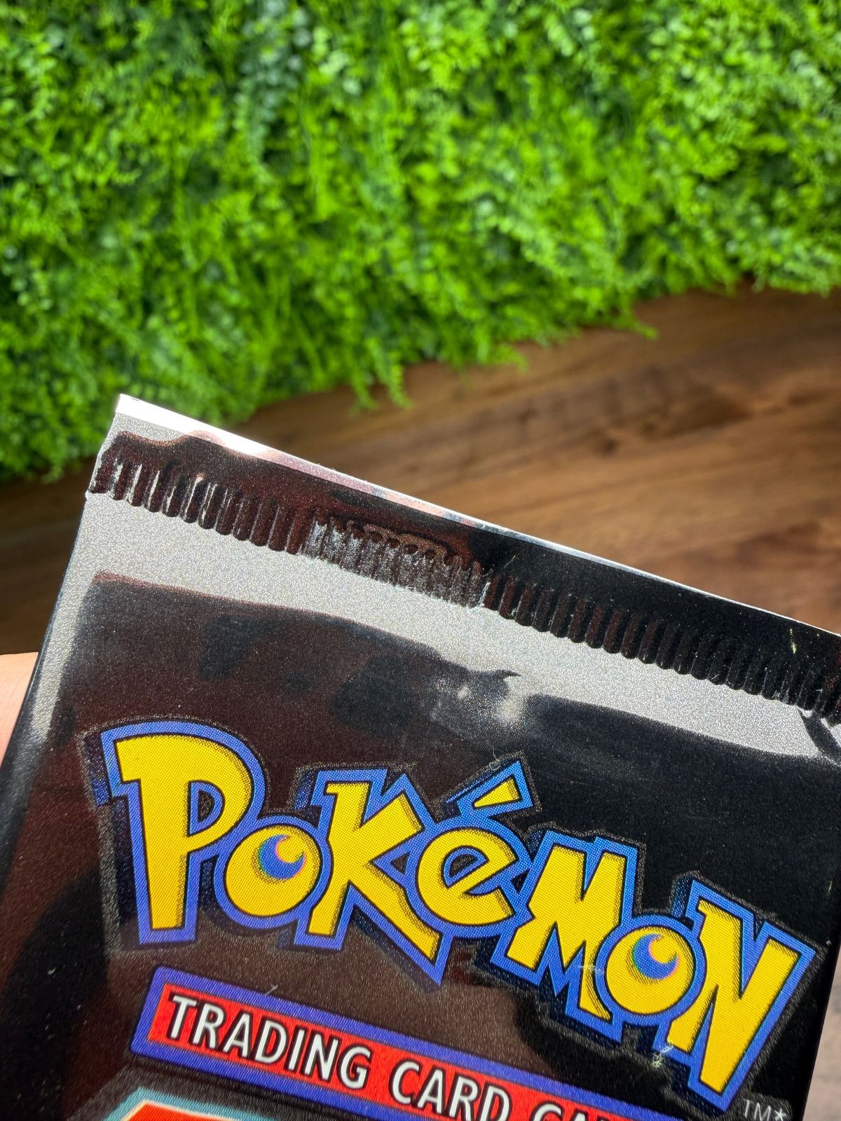 Factory crimp slits on a Team Rocket pack, where the sealing jaws cut the foil behind the spine.