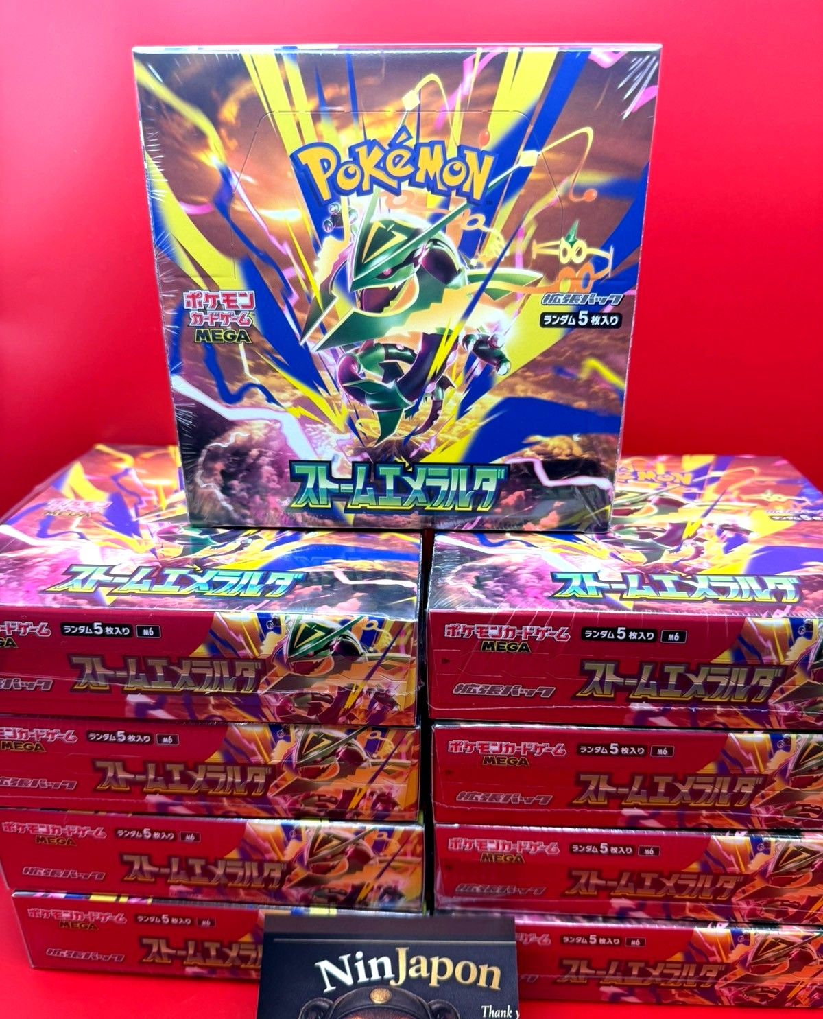 A stack of Japanese booster boxes in plain, unprinted shrink film.