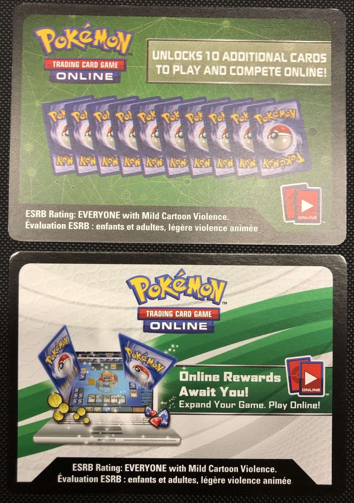 The backs of two Pokémon TCG Online code cards: one dark green, one white and green.