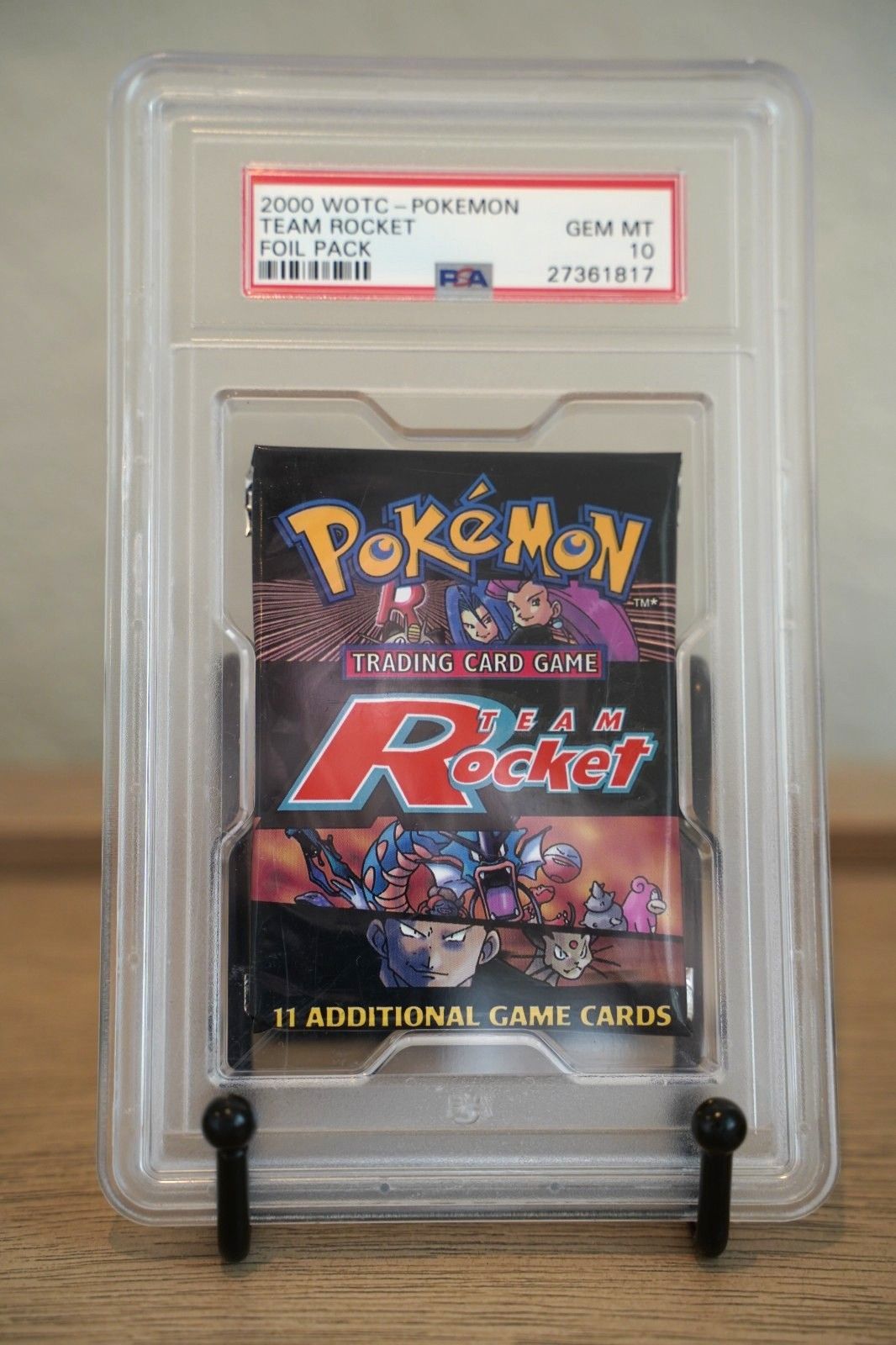 A Team Rocket booster pack sealed in a PSA GEM MT 10 holder.
